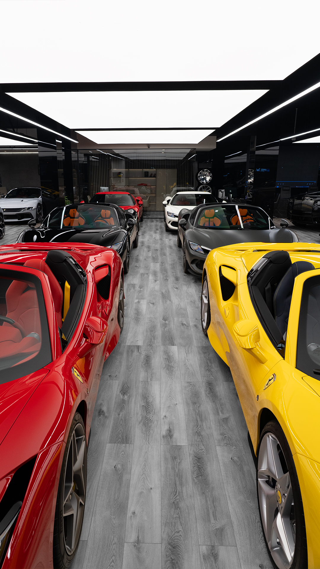 Central showroom aisle between red and yellow supercars